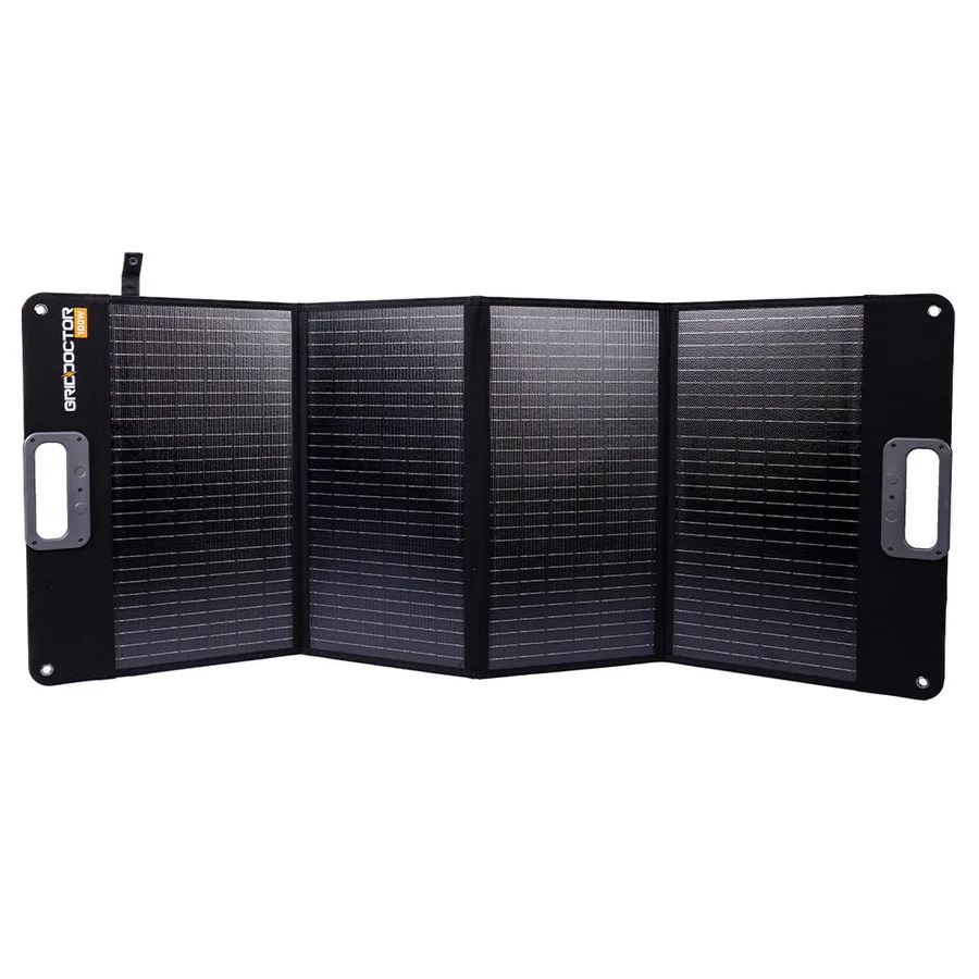 The Grid Doctor 100W folding solar panel opened flat into four sections, with a carry handle at each end